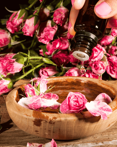 essential oil drop in water with flower petals