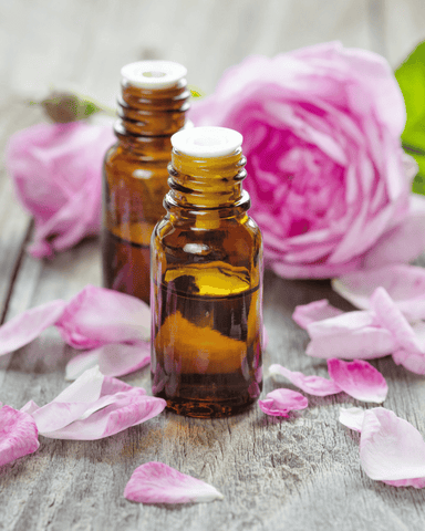 essential oil bottles and flowers on the table