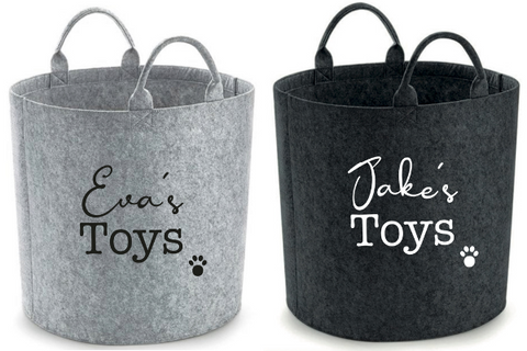 A pair of dog toy storage baskets from Pooch. The left one is grey, the right one is charcoal colour.