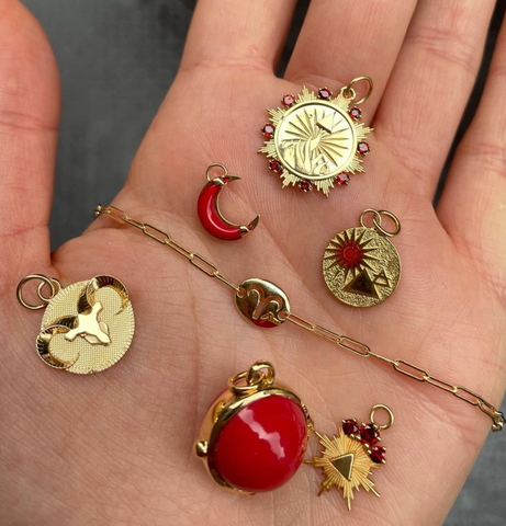 hand holding different aries and red medallions
