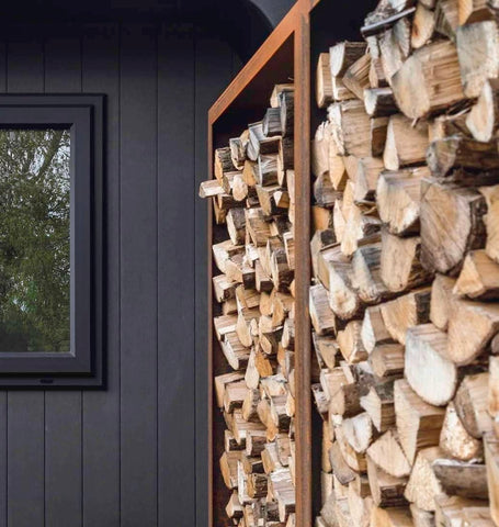 vertical corten steel wood store stacked with wood