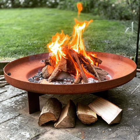 Wood burning on a fire pit in a garden