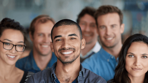 Head shot of a group of 6 adults, all happy and smiling.  