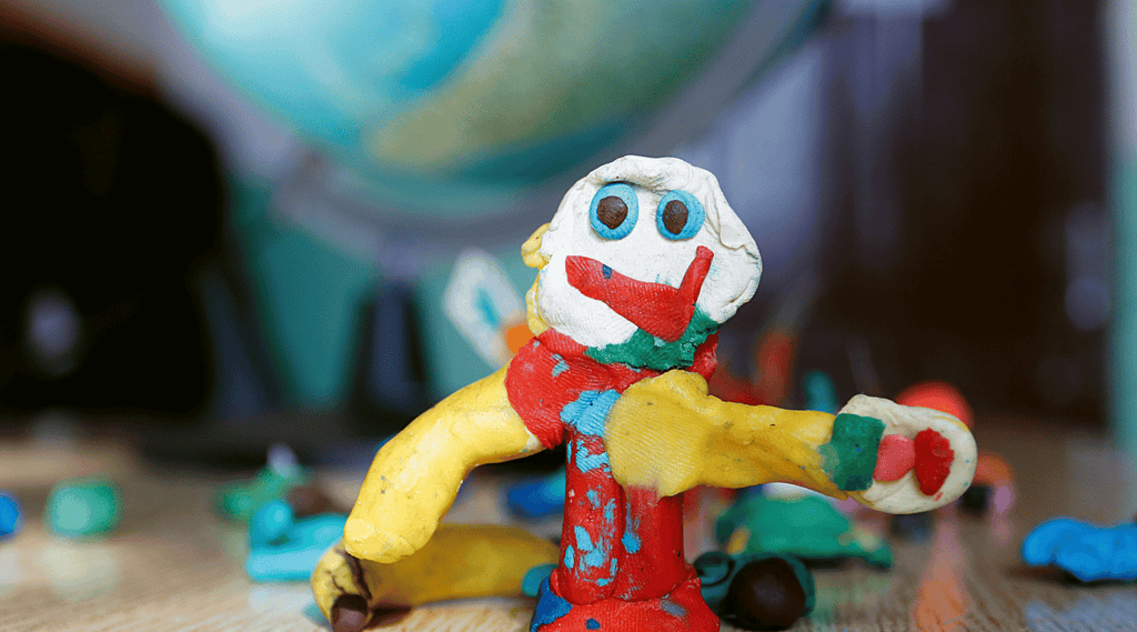 Art Therapy for Psoriasis - Fruit figures made of play doh on the globe.