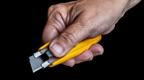 A hand holding an OLFA sk-9 knife