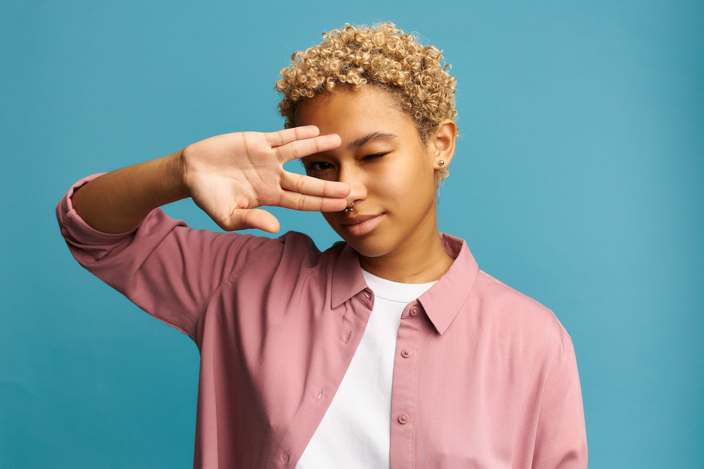 african american woman with pink shirt and coily hair