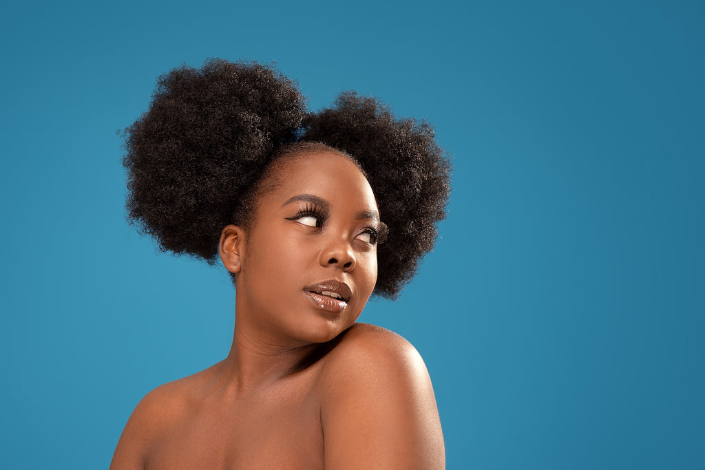 girl with type 4c coily hair on a blue background
