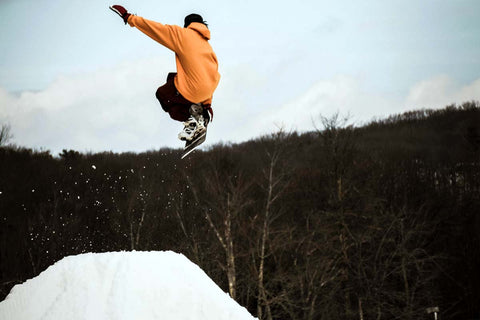 Person doing a trick on a freestyle snowboard