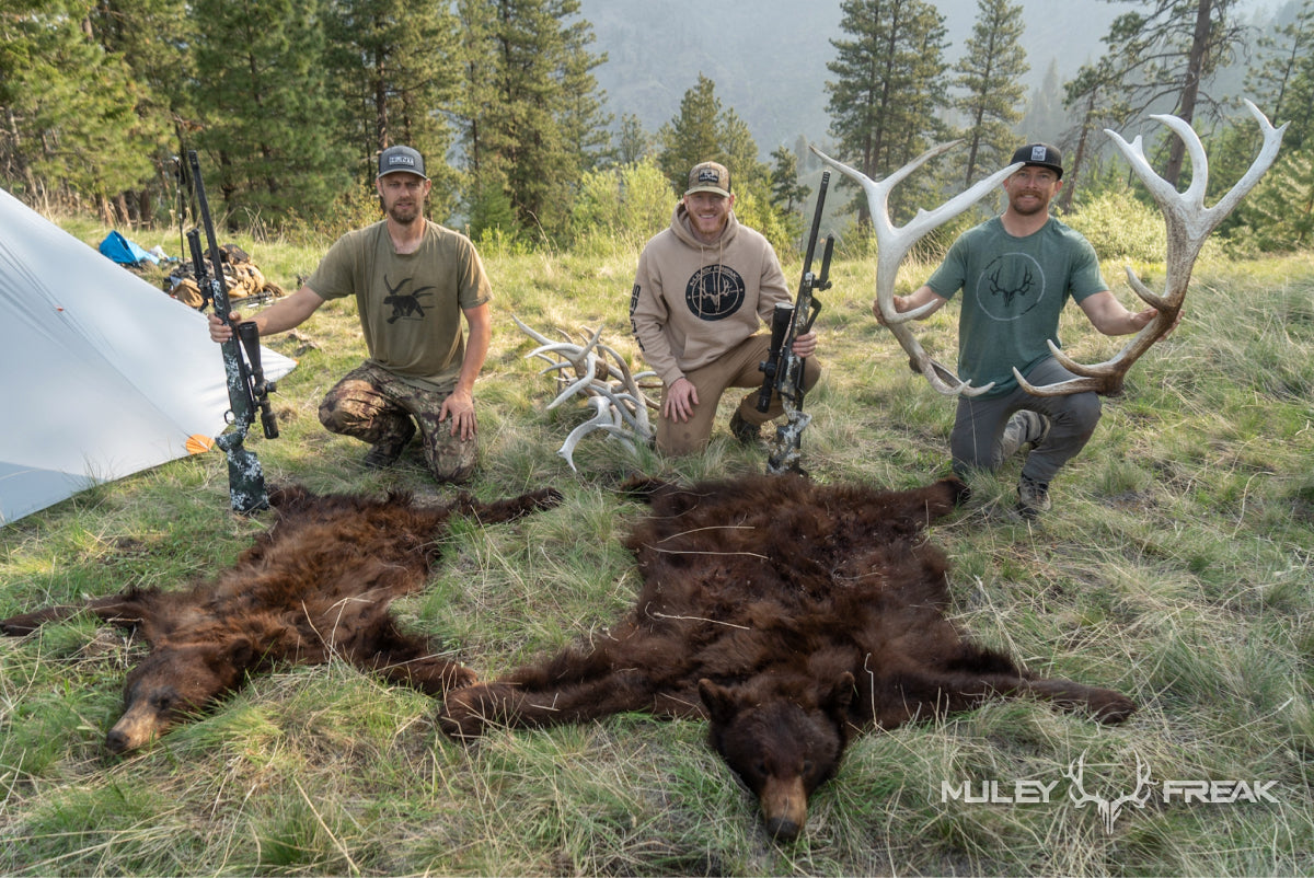 The Muley Freak crew sitting beside a couple of black bears and elk sheds in the backcountry of idaho