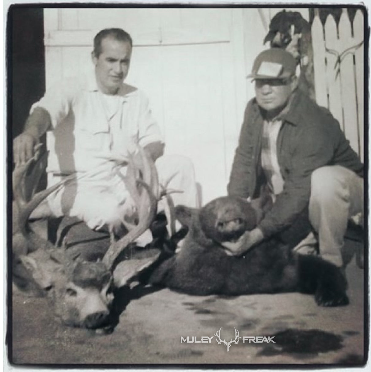 John Van Woerkom holding a buck and bear he shot