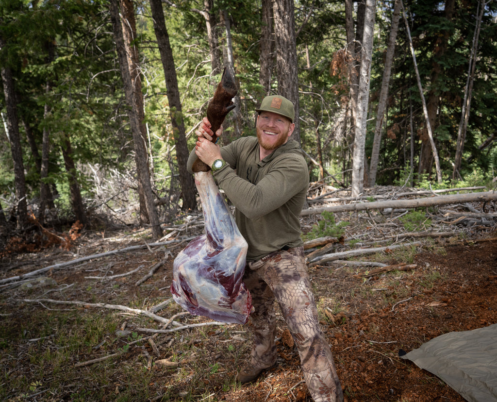 Erik Van Workom Holding up quartered elk meat after a recent hunt