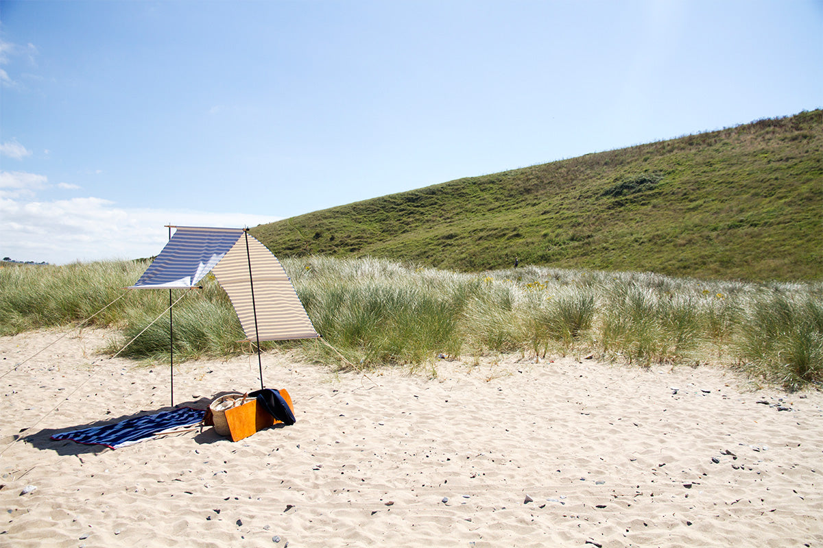 makeshift shelter on sunny beach 