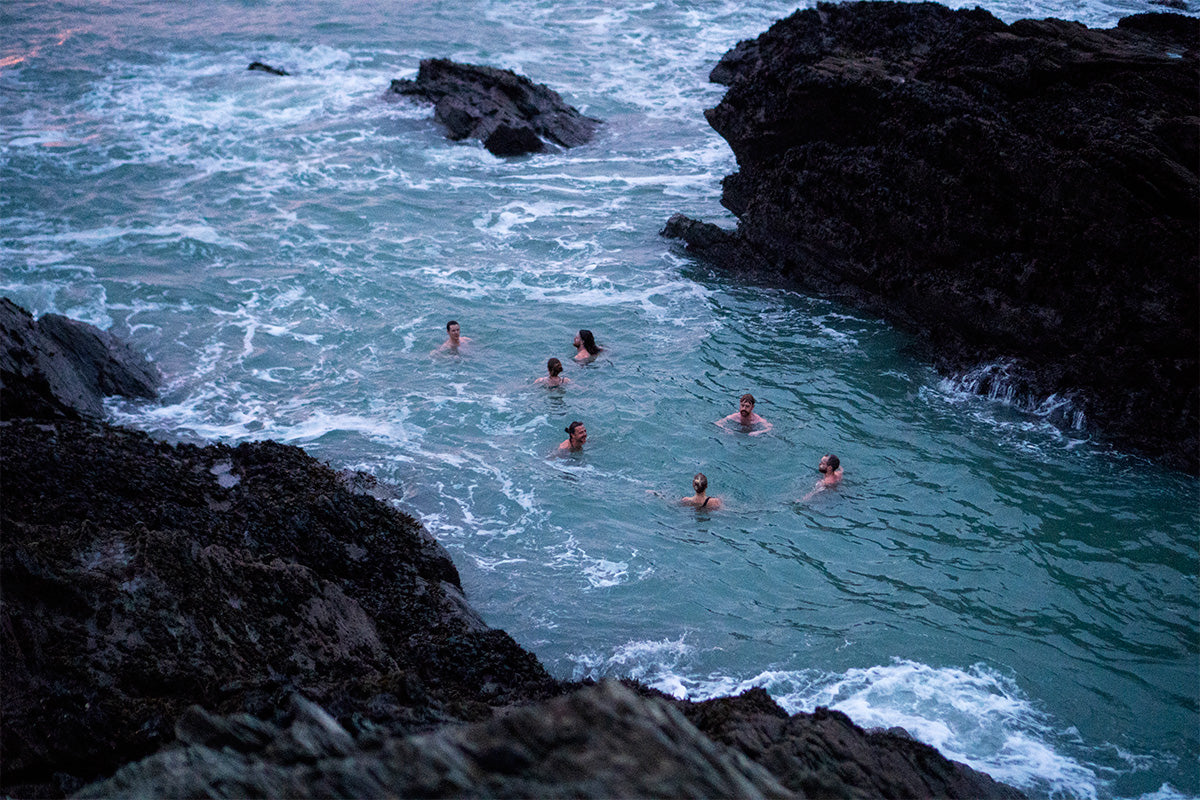 group of people swim in the sea in winter 