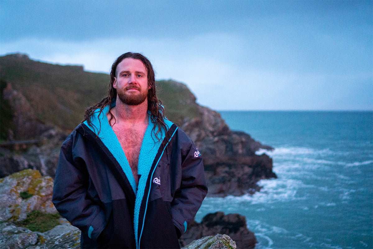 Anthony Mullally stands in his dry robe in front of the sea