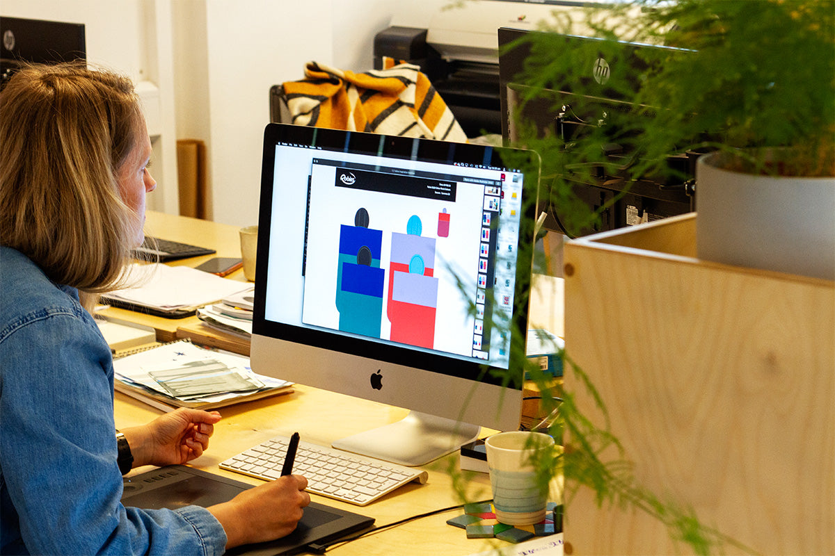 blonde woman working on graphic design on a computer 