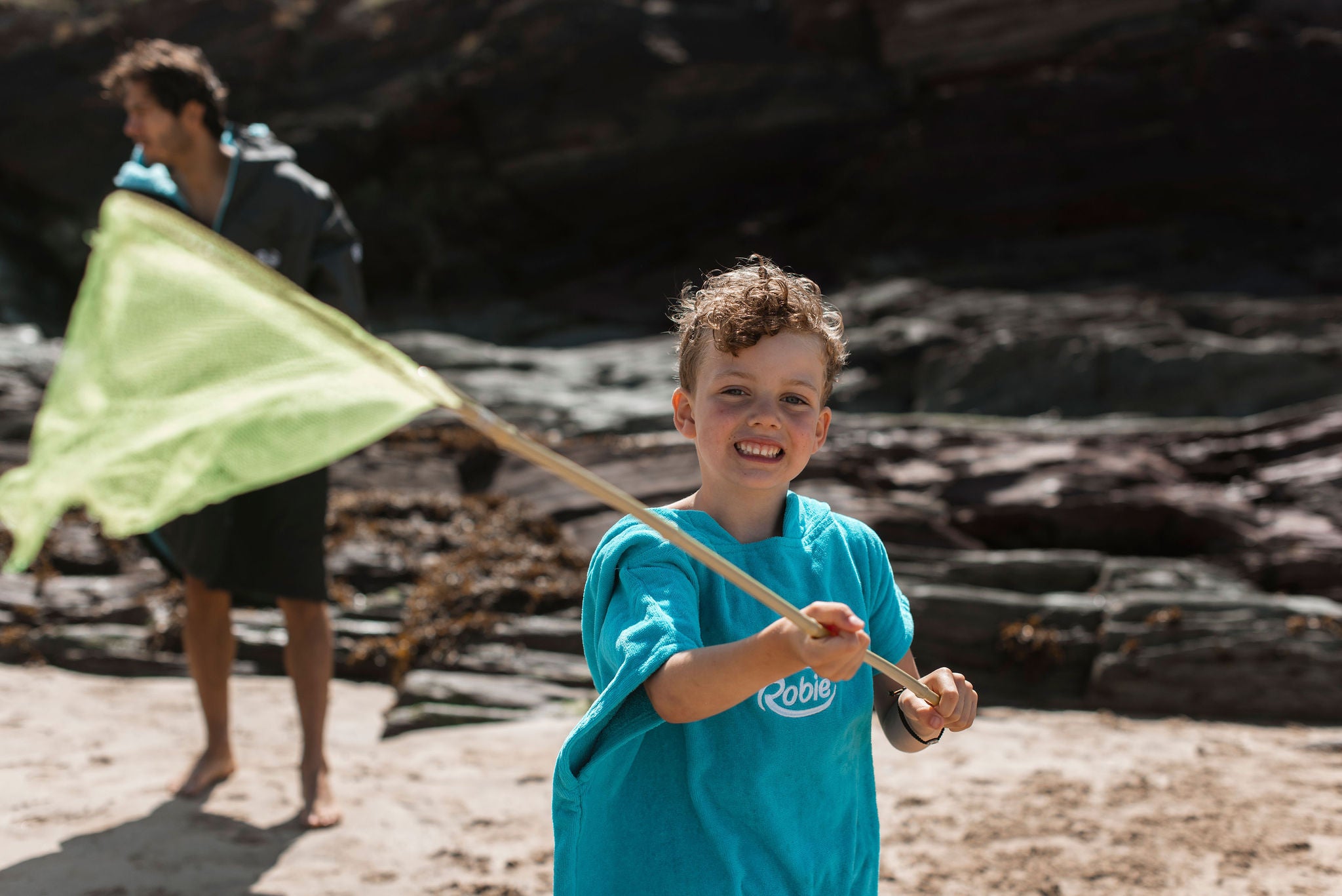 boy with fishing net on the beach 