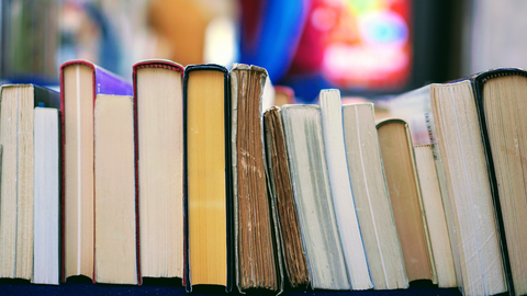 row of books staked down with the spine up 