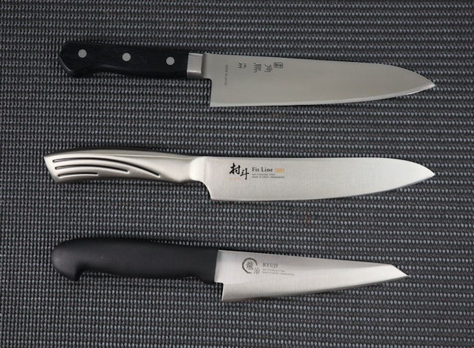 3 Quality Hand finished Japanese kitchen knives, all priced under $100, arranged vertically. The top knife is a Tu-9000 series Gyuto (Chef/Cook) kitchen knife with a stainless-steel blade attached to a Pakka wood handle with three rivets. The blade has a curved profile from heel to tip. The middle knife is a Fit series Gyuto (Chef/Cook) kitchen knife 180mm. An all stainless-steel knife with the blade integrated  into the handle. The blade is narrower than a lot of Gyuto's with a curved profile from heel to tip. The bottom knife is a traditional Japanese boning knife, Honesuki 150mm. The stainless steel blade has an almost triangular blade with a straight profile from heel to the pointed tip and a Black resin handle. 