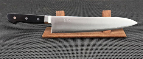 Ohishi VG5 Stainless-steel Handmade 240mm Gyuto (Chef/Cook) Japanese Kitchen Knife with a Black Pakka Wood handle with 3 rivet and a Migaki (Polished) finish on a red wood stand