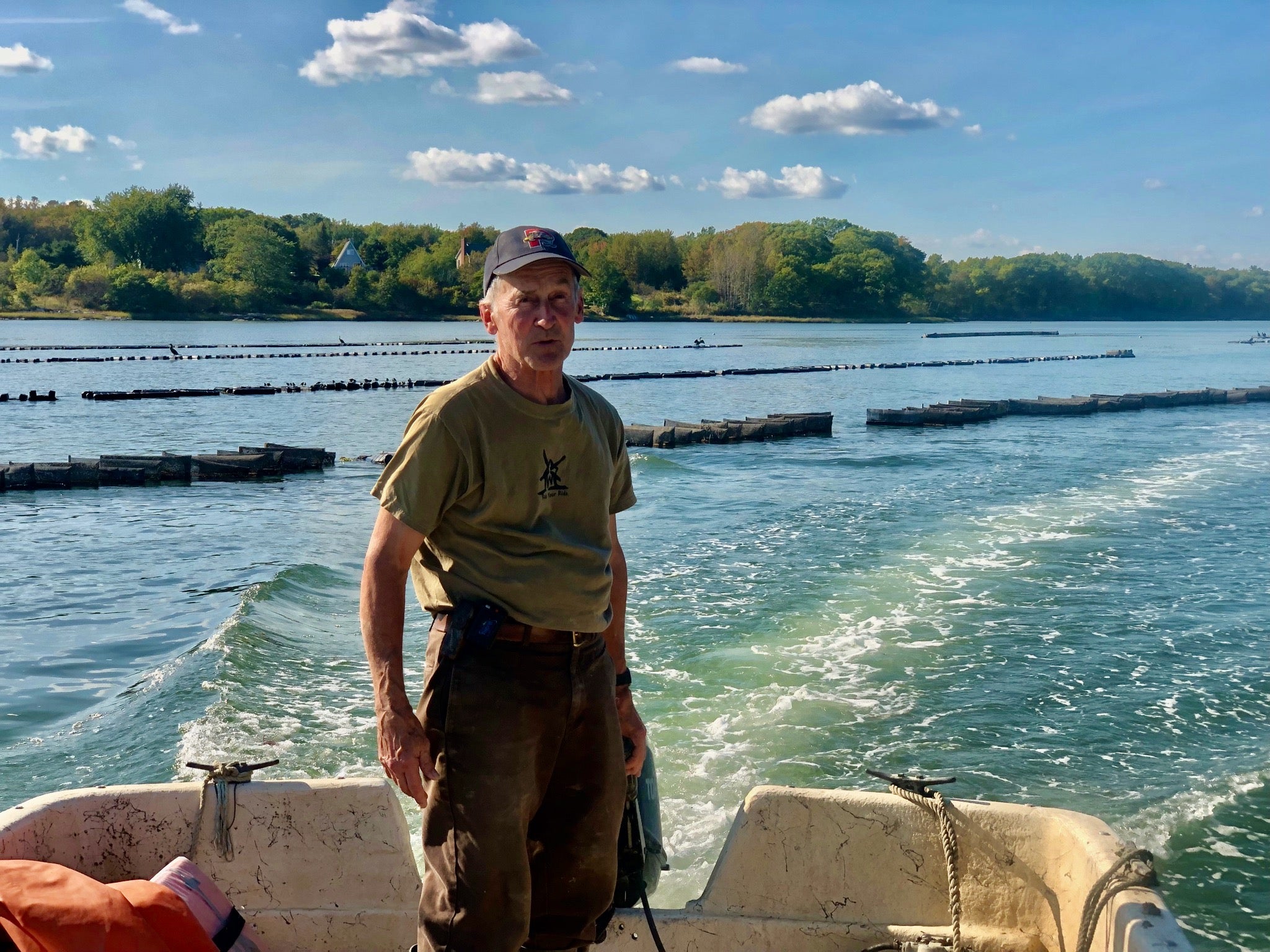 Oyster Farm manager, Ralph Hamill on the skiff.