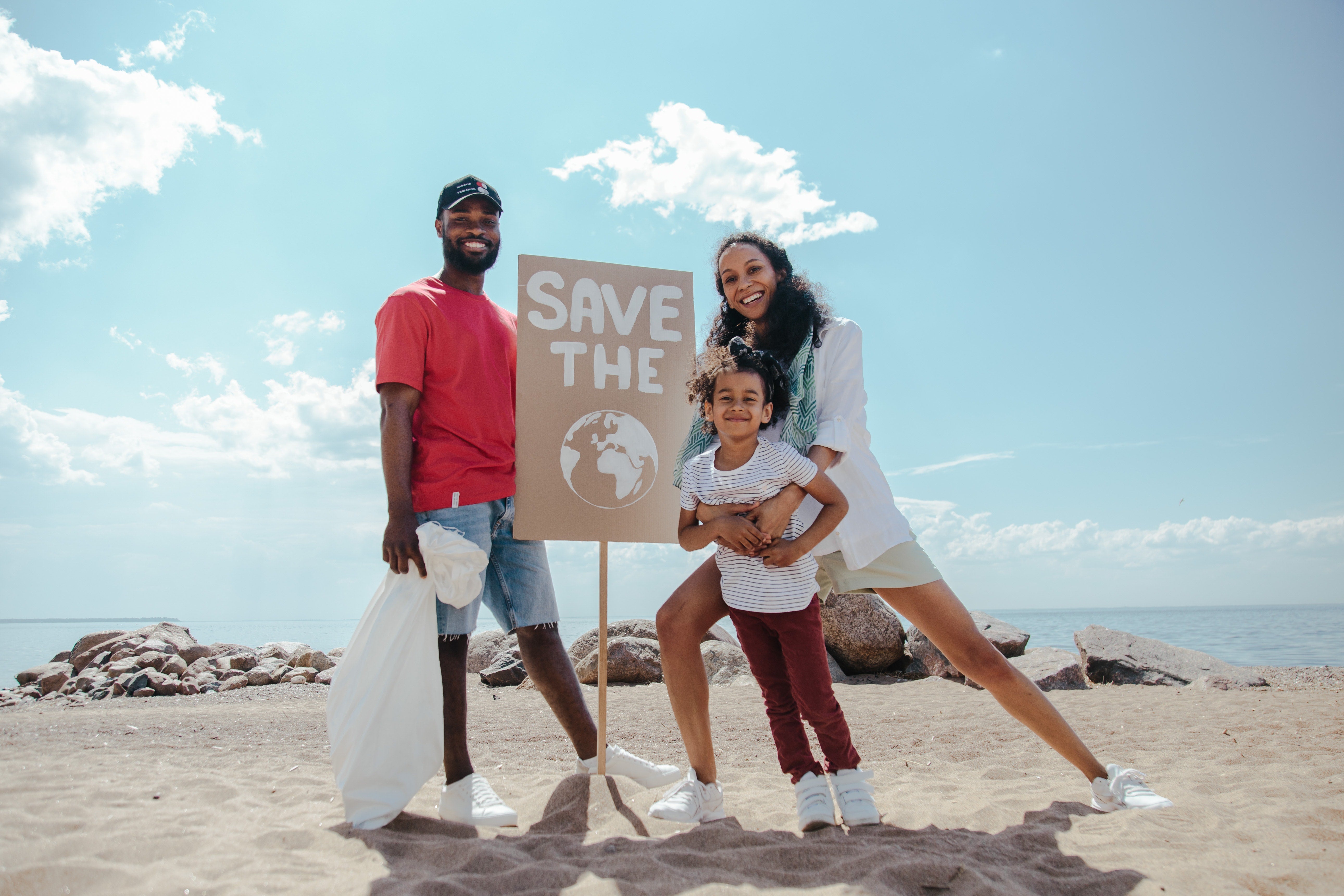 happy family cleaning up beach save the earth 