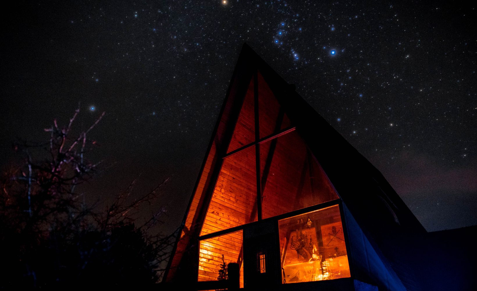 Dimly lit cabin under stars