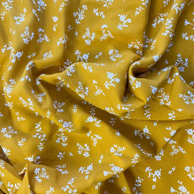 A wonderful yellow fabric with white flowers. A lovely dressmaking and sewing viscose fabric.