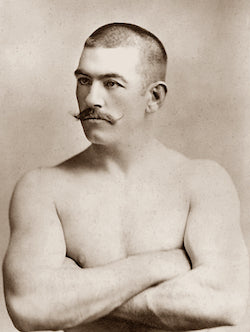 John Lawrence Sullivan (October 15, 1858 – February 2, 1918), also known as the Boston Strong Boy, in his prime. He was recognized as the first heavyweight champion of gloved boxing from February 7, 1882 to 1892, and is generally recognized as the last heavyweight champion of bare-knuckle boxing under the London Prize Ring rules