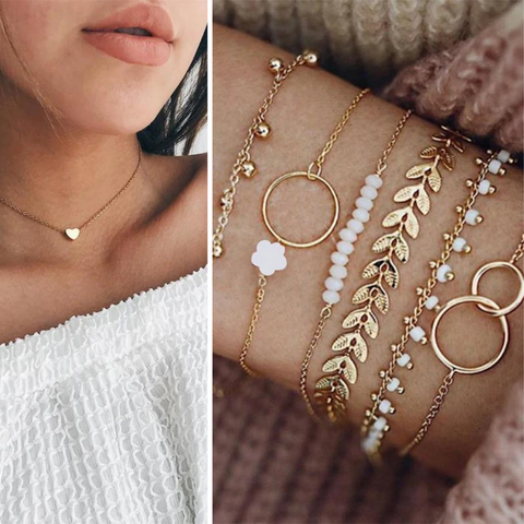 two pieces of delicate gold jewelry being modeled