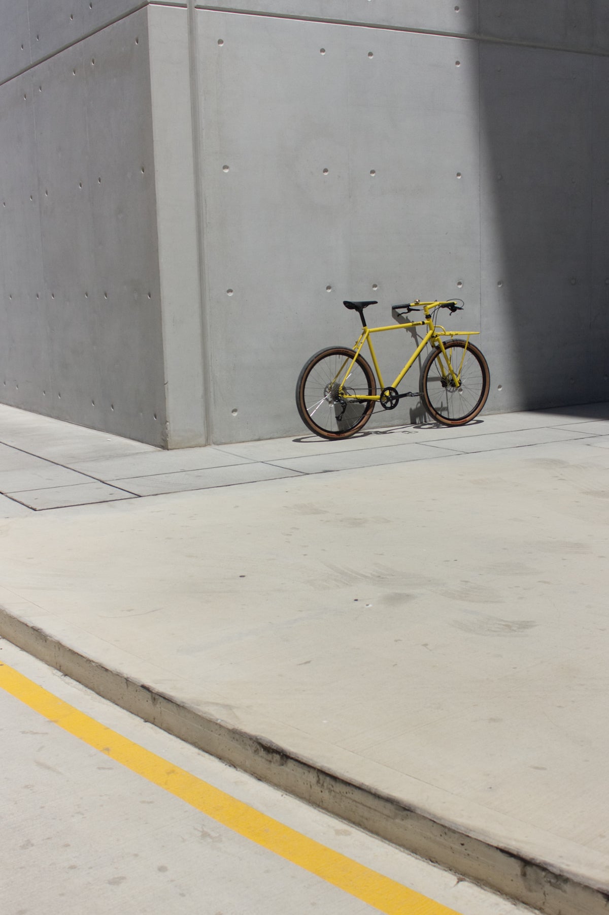 Donhou utility bike mustard yellow against wall