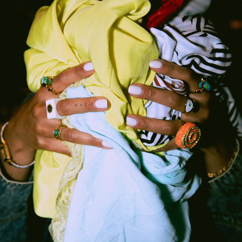 woman hands holding a pile of clothing