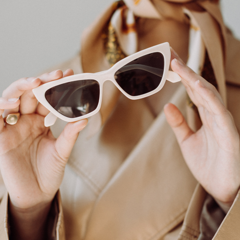 woman hands holding classic vintage sunglasses