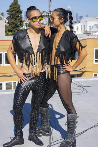 two people wearing leather and studded pride costumes