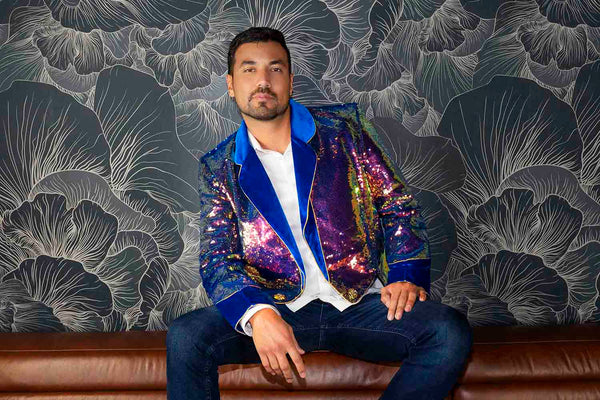 a man wearing a blue and gold sequin jacket