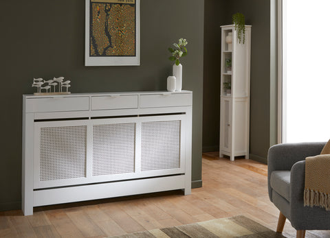 Large three drawer radiator cover in white with summery rattan styled panels and matching tallboy cabinet