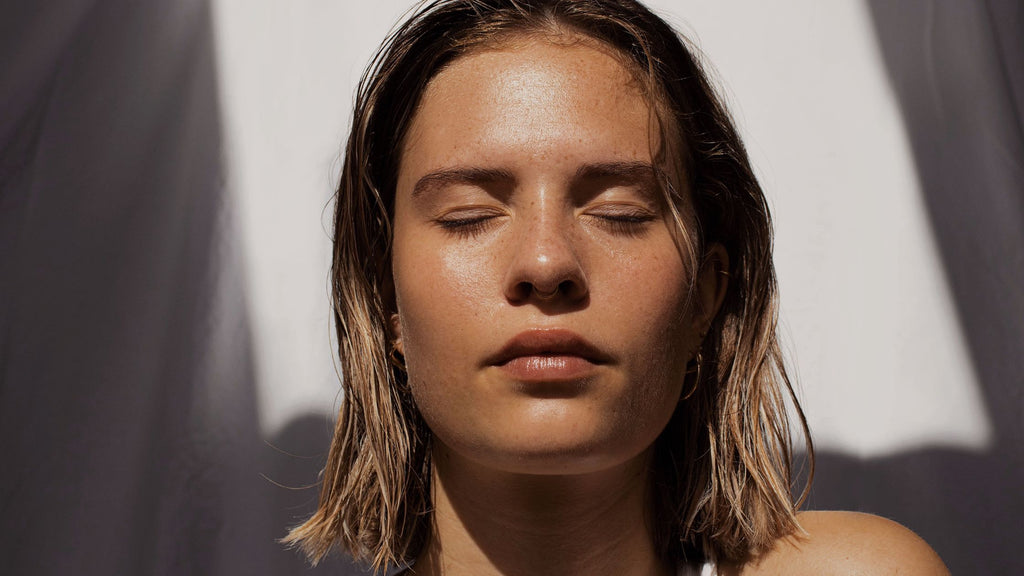 lady enjoying the sun on her face with her eyes closed