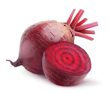 Whole and sliced red beetroot on a white background.