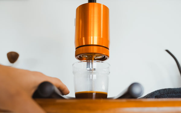 Espresso coffee filling a glass mug