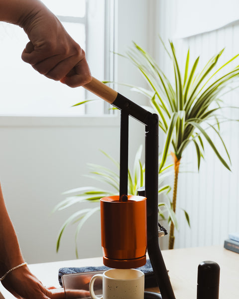 person operating the Newton BRUA espresso maker