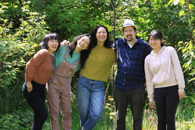 The Mominoki team standing in nature.