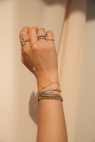hand wearing several rings and bracelets