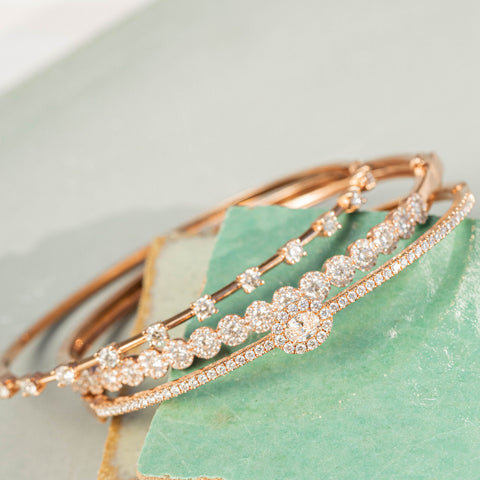 Gold bangles resting on corner of magazine stack