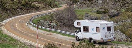 Camper with Battery Driving on Back Road