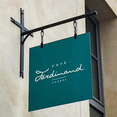 Square enamelled sign on wrought iron gallows Café Ferdinand