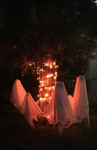 Outdoor ghost display for Halloween at night with creepy red lighting