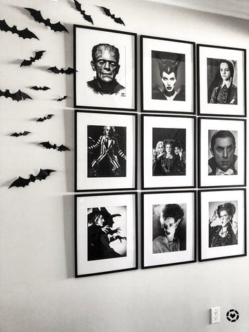 A monochrome gallery wall featuring fictional characters related to Halloween