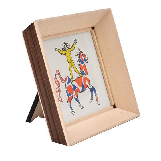 A wooden tabletop frame displaying artwork