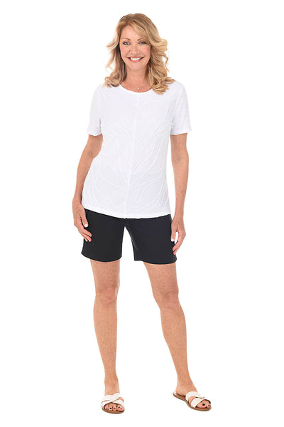 Val wearing a white tee and black Coconut Row shorts