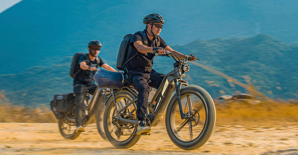 Two men riding electric bikes