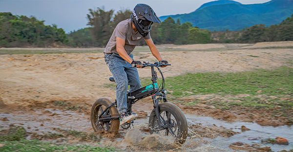 Man riding electric bike through mud